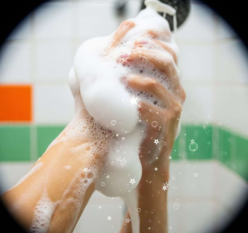 Playful Shower Selfie: Hands Lathering Soap with Star Bubbles