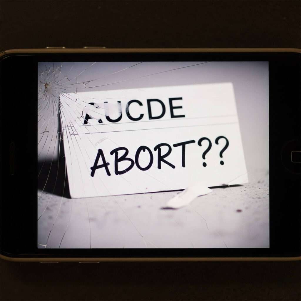 Discarded cue card with 'ABORT???' scribbled on it.